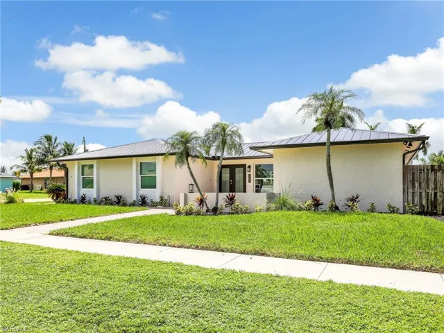 Ranch-style home featuring a front yard