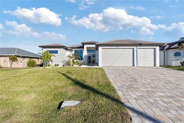 Prairie-style home with a garage and a front yard