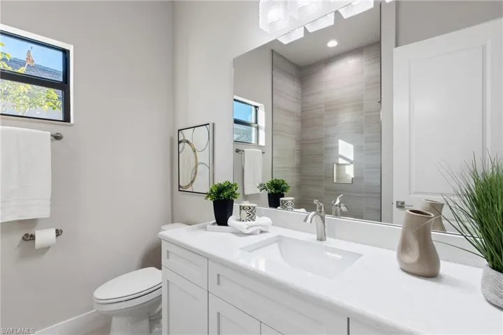 Bathroom featuring plenty of natural light, vanity, and toilet