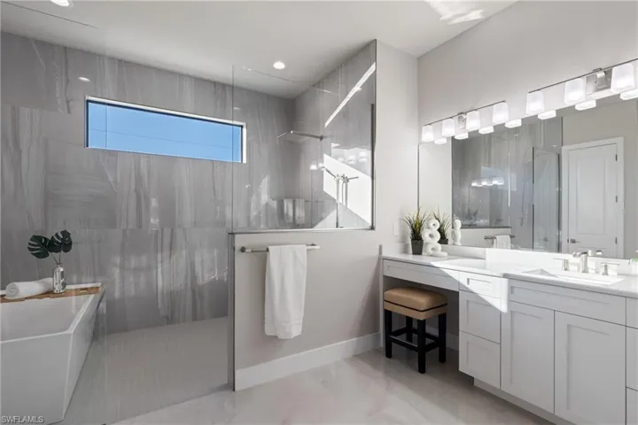 Bathroom with vanity and plus walk in shower