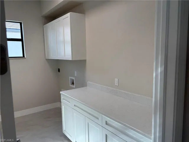 Washroom with cabinets and washer hookup