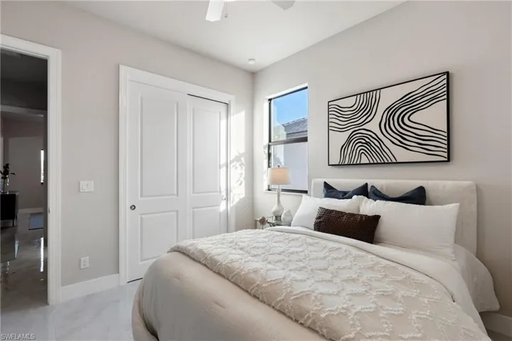 Bedroom featuring ceiling fan and a closet