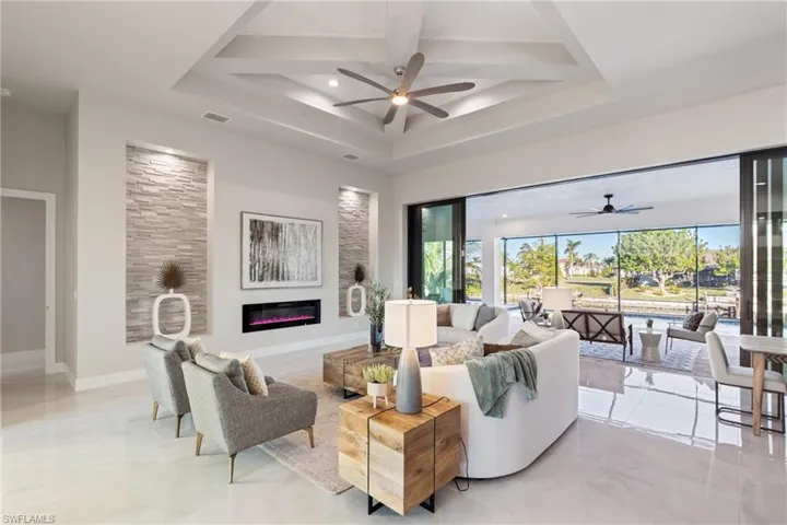 Living room with ceiling fan and coffered ceiling