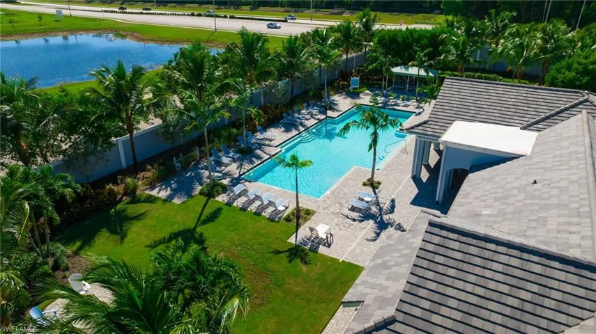 Community pool featuring a patio area and a water view