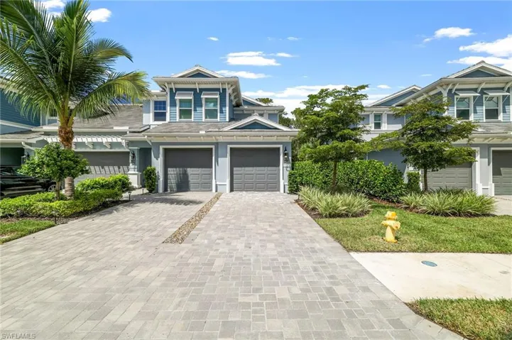View of front of home with driveway and a garage