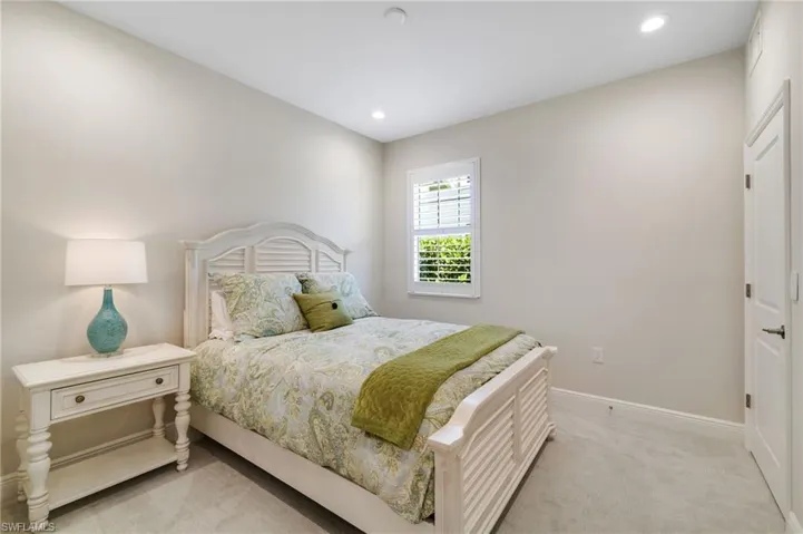 Bedroom featuring light colored carpet and recessed lighting