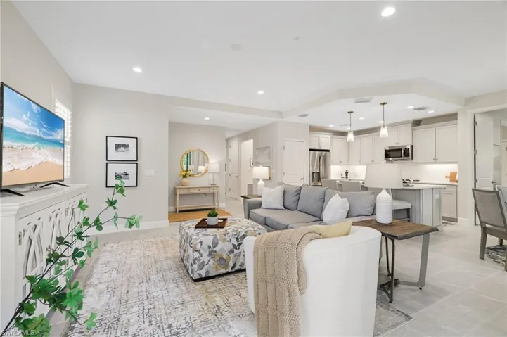 Living area with recessed lighting and baseboards