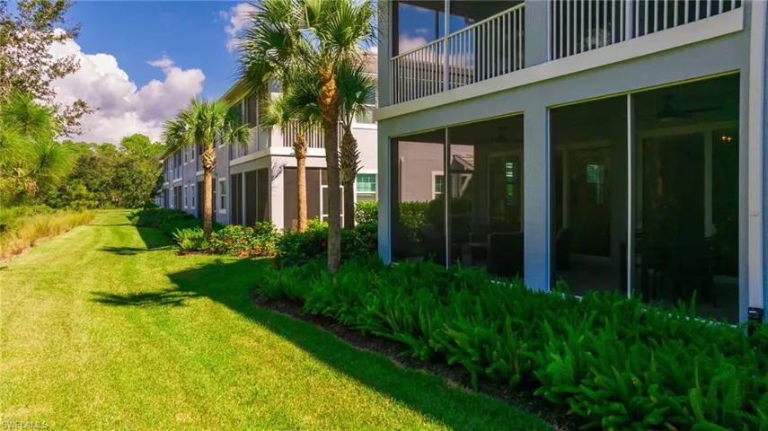 View of grassy yard with the sunroom that looks out into peaceful yard