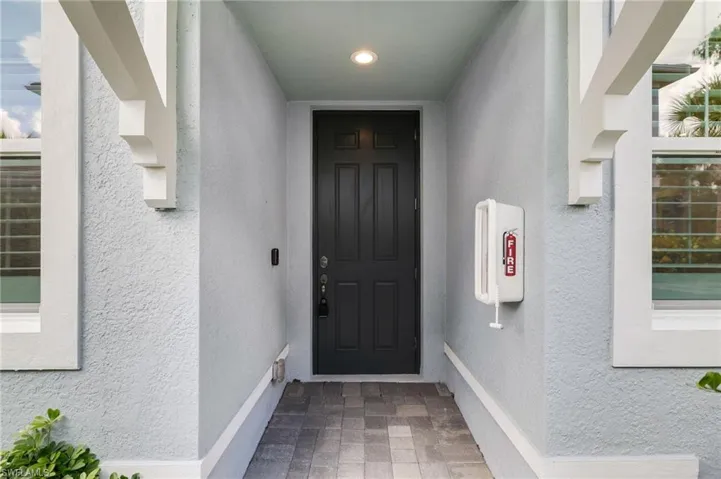 View of exterior entry featuring stucco siding