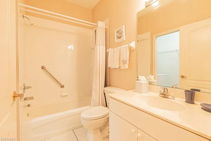 Full bathroom featuring tile patterned flooring, shower / tub combo, vanity, and toilet