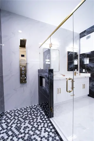 Bathroom featuring vanity and a shower with shower door