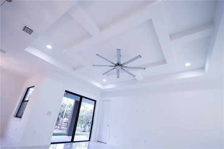 Room details featuring ceiling fan and a tray ceiling