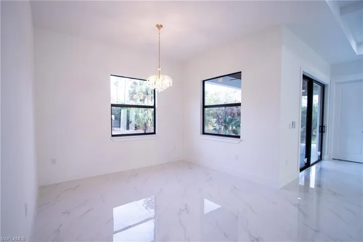 Empty room featuring an inviting chandelier