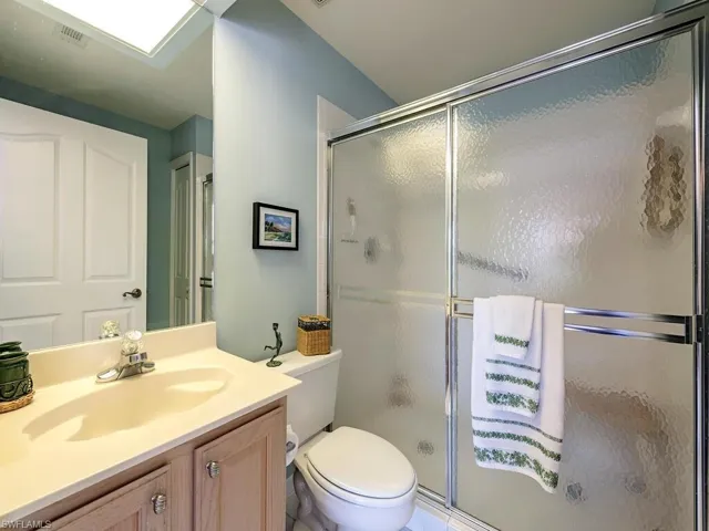 Full bathroom with vanity and a shower stall