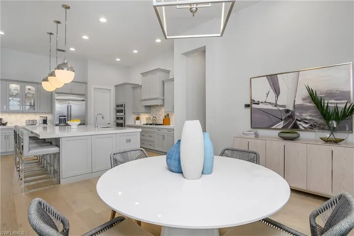 Dining room with sink and light hardwood / wood-style flooring