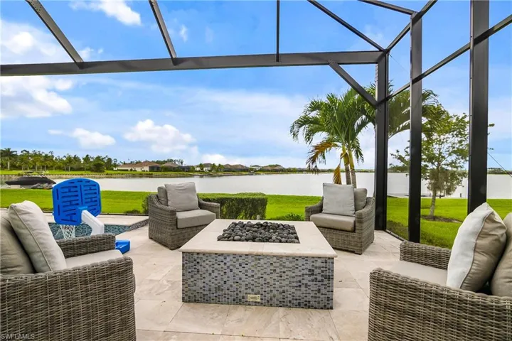 View of patio featuring a water view and an outdoor living space with a fire pit