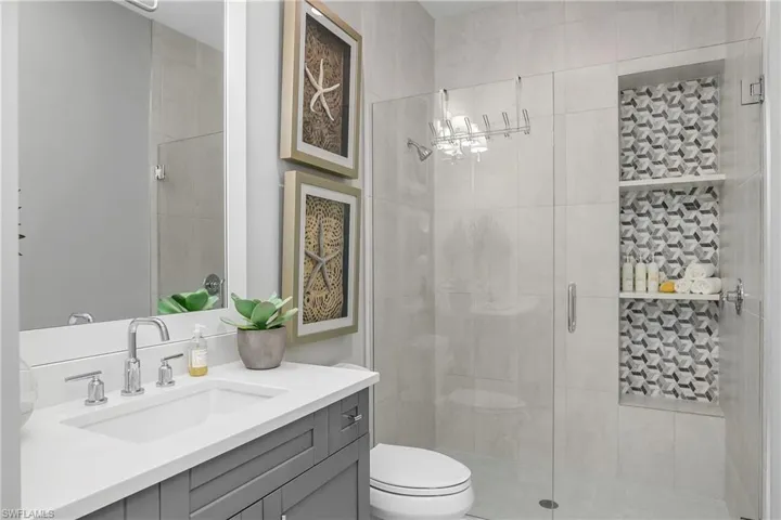Ensuite bath for bedroom #2 with custom walk-in shower.