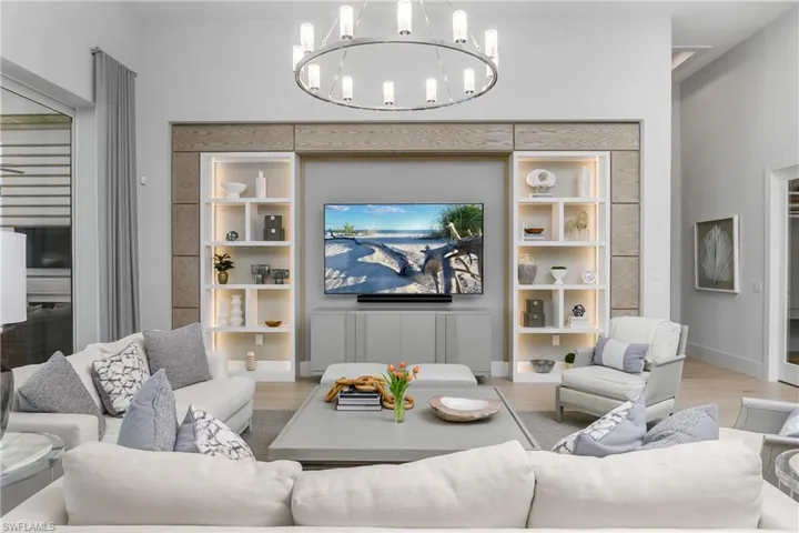 Living room featuring a notable chandelier and light hardwood / wood-style flooring