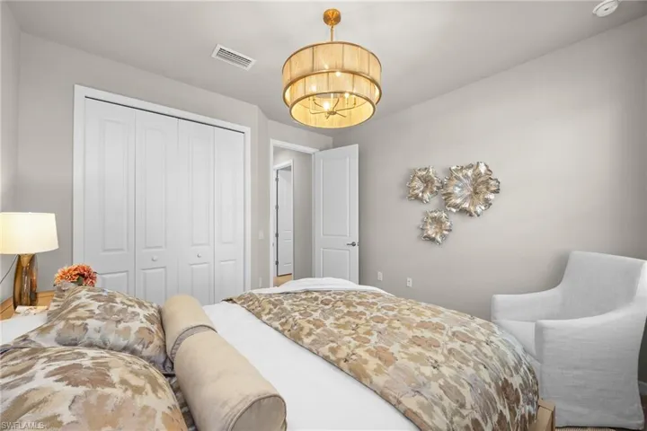 Bedroom with a closet and a chandelier