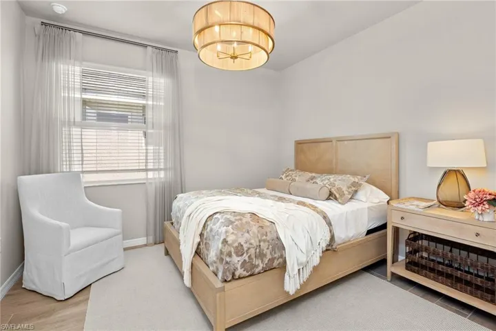 Bedroom featuring a chandelier and baseboards
