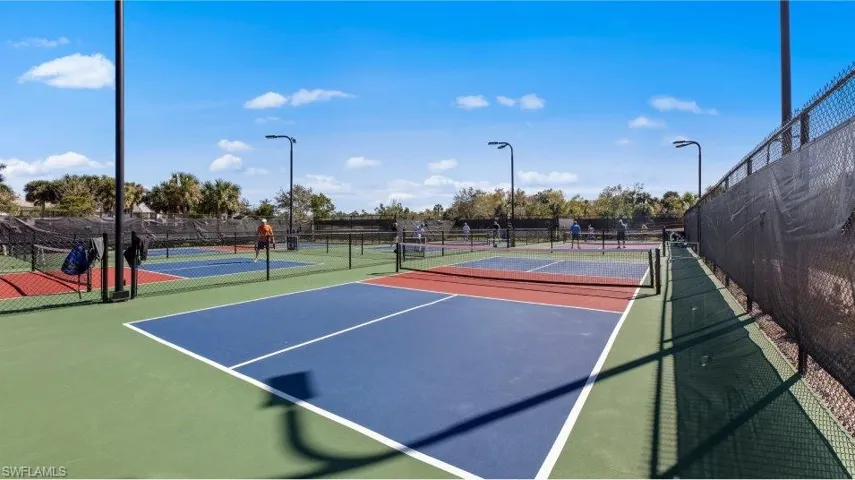 View of tennis court with community basketball court