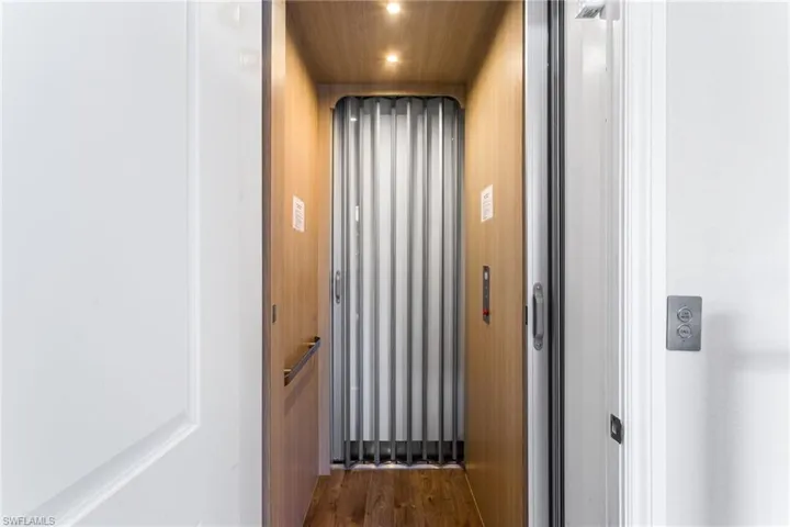 Elevator featuring wood finished floors and wood ceiling