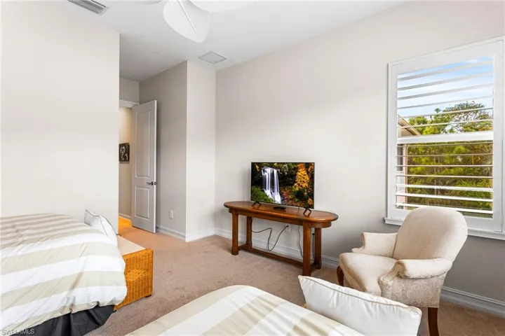 Bedroom with carpet floors and a ceiling fan