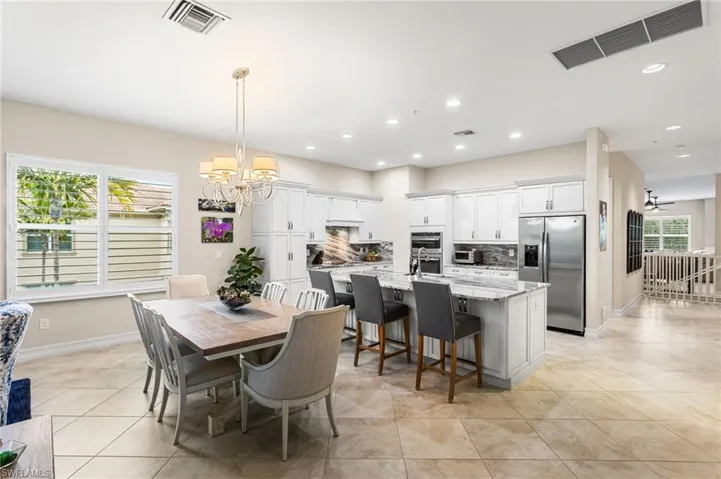 Dining area featuring hanging lights and light tile patterned floors