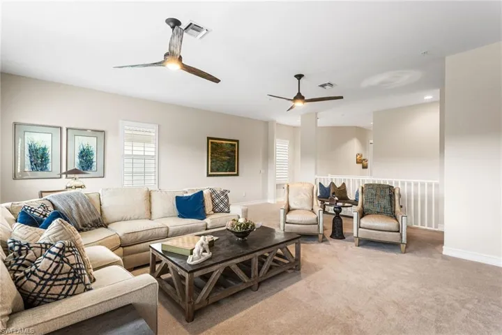 Living area featuring carpet, a ceiling fan, and recessed lighting