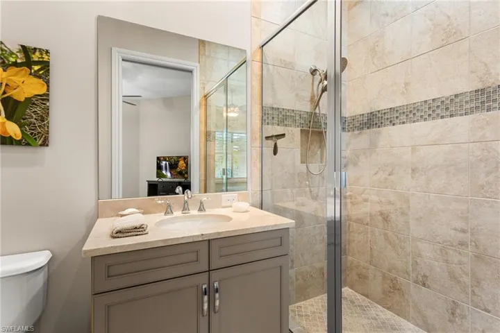 Bathroom featuring vanity and a shower stall