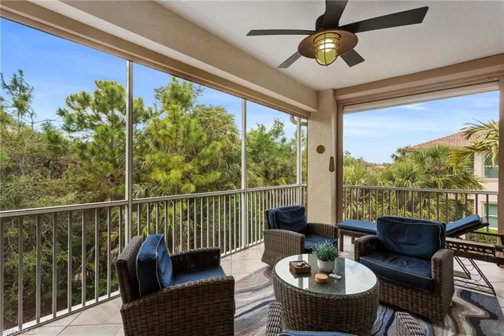 Sunroom / solarium featuring outdoor seating, a ceiling fan, and a balcony