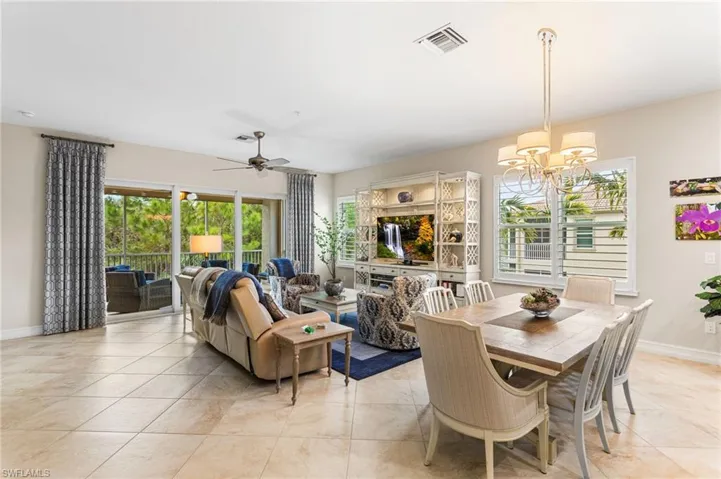 Dining space with ceiling fan, suspended lighting, and light tile patterned floors
