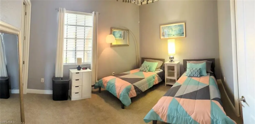 Bedroom with light colored carpet