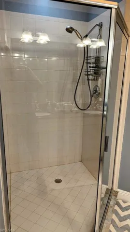 Bathroom featuring walk in shower and tile patterned floors