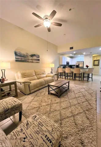 Living room with ceiling fan and a textured ceiling