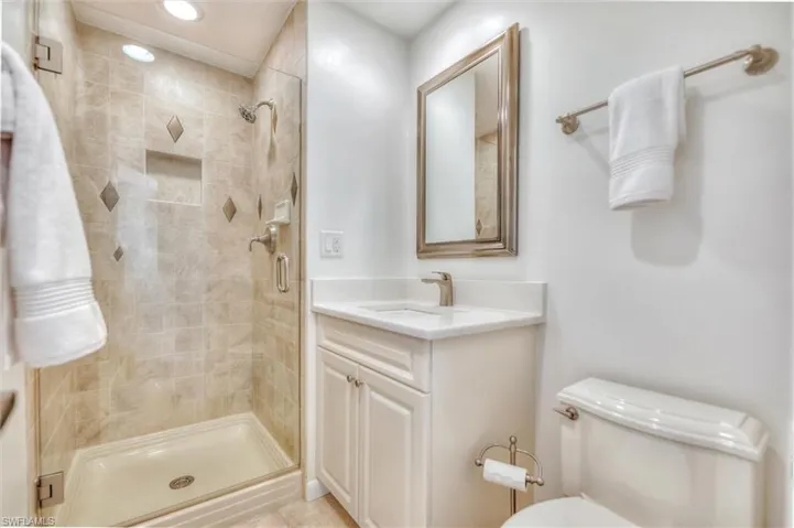 Full bath featuring vanity, enclosed tub / shower combo, tile patterned floors, and recessed lighting