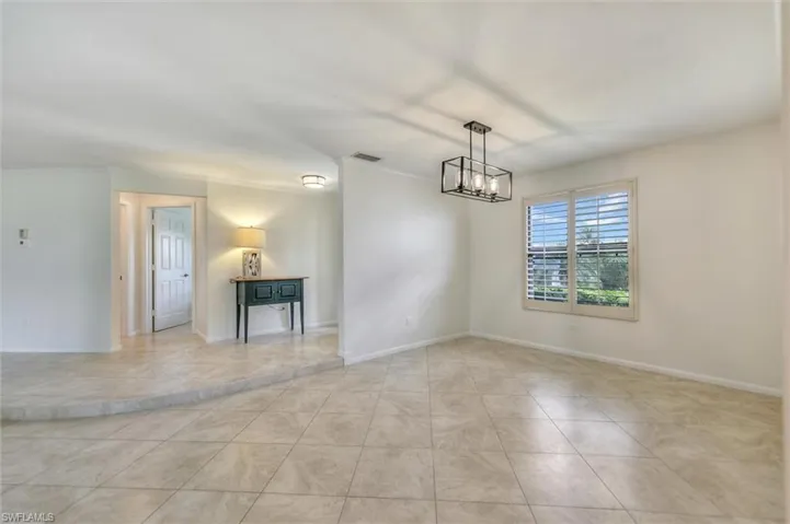 Unfurnished room featuring a ceiling fan and tile patterned flooring
