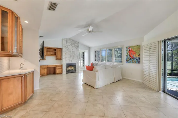 Living area featuring light tile patterned floors and ornamental molding