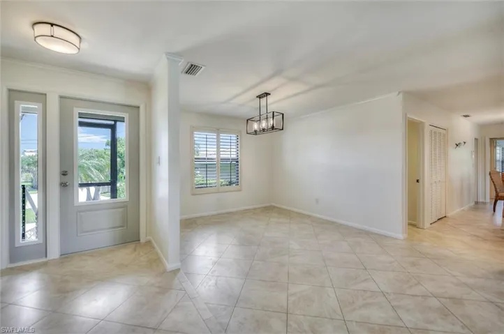 Bedroom with a ceiling fan and light tile patterned flooring