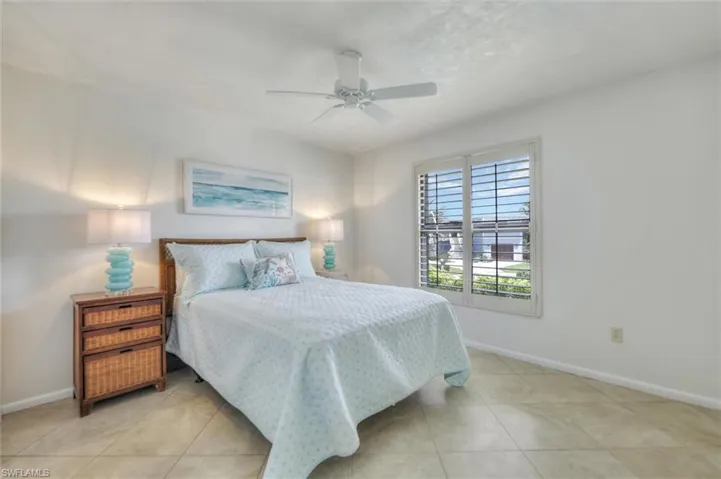 Living room with ceiling fan, light tile patterned floors, and recessed lighting