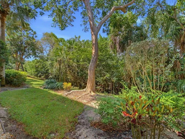 Lush tropical landscaping creates a serene, private backdrop that reflects the celebrated natural beauty of Fiddler’s Creek.