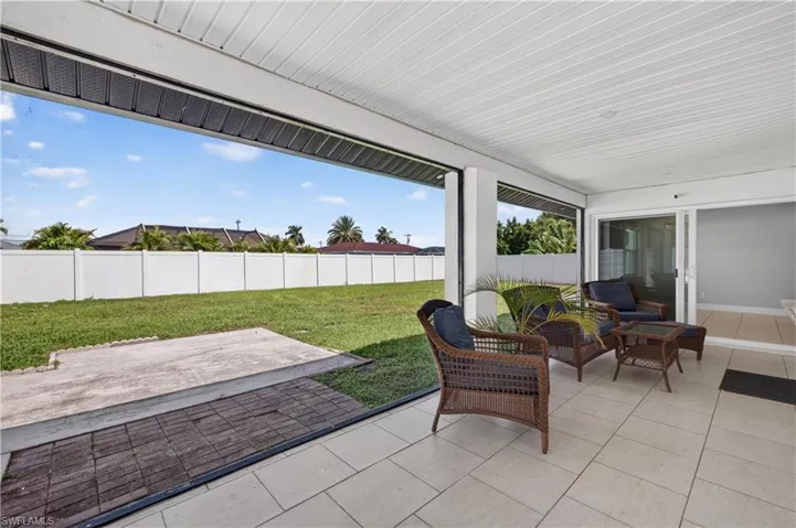Screened-in patio featuring tile flooring and a white slatted ceiling