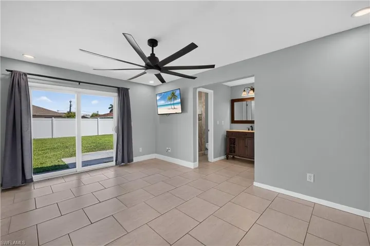 Spacious room featuring large format tile flooring, a contemporary ceiling fan, and recessed lighting