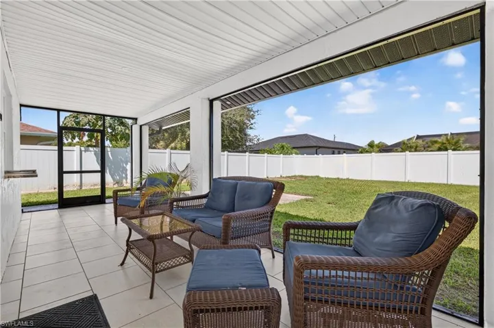 Screened patio with tile flooring and a white paneled ceiling