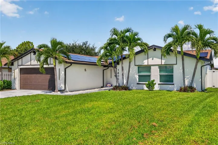 White stucco exterior with dark trim accents