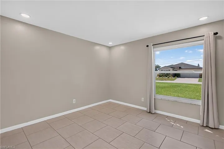 Recessed ceiling lighting, tiled flooring, window with natural lighting, and neutral wall tones