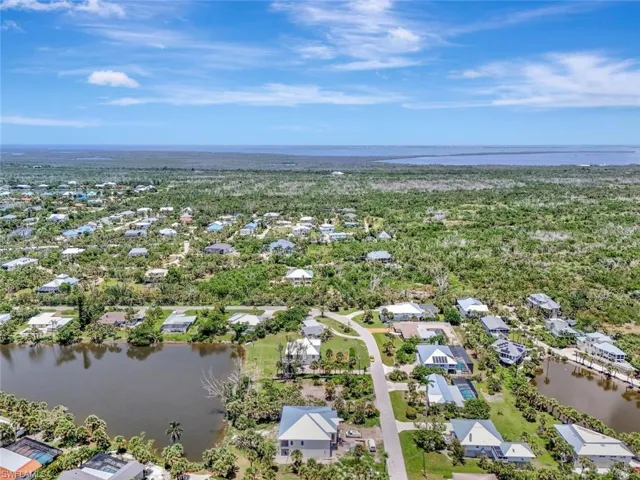 Aerial view of residential area featuring a nearby body of water
