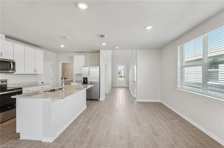 Kitchen featuring a sink, visible vents, baseboards, and stainless steel appliances