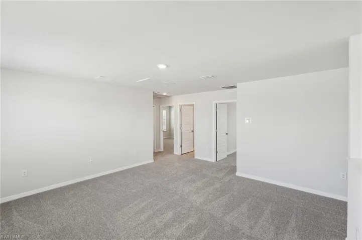 Unfurnished room with recessed lighting, baseboards, and carpet floors