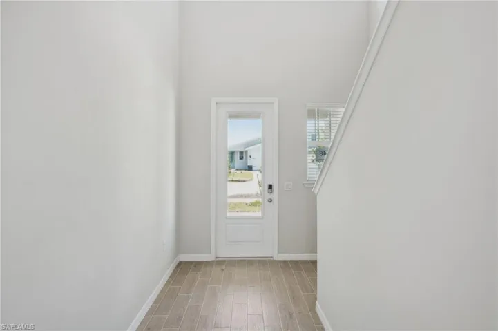 Entryway with light wood-style flooring and baseboards